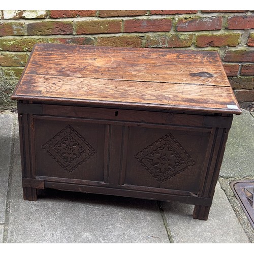 619 - A 17th Century oak coffer, two panel front with ornately carved diamond lozenge, wrought iron mounts... 