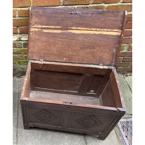 619 - A 17th Century oak coffer, two panel front with ornately carved diamond lozenge, wrought iron mounts... 