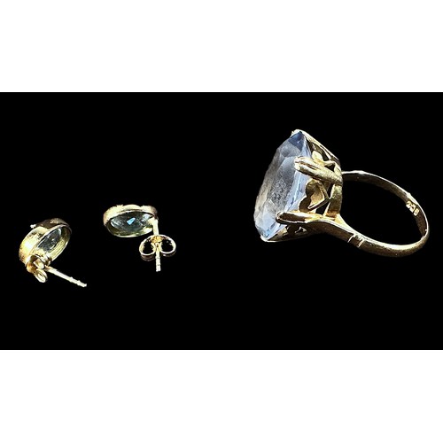 254 - A 9ct gold ring, centrally claw set with with a large oval faceted blue topaz coloured stone, togeth... 