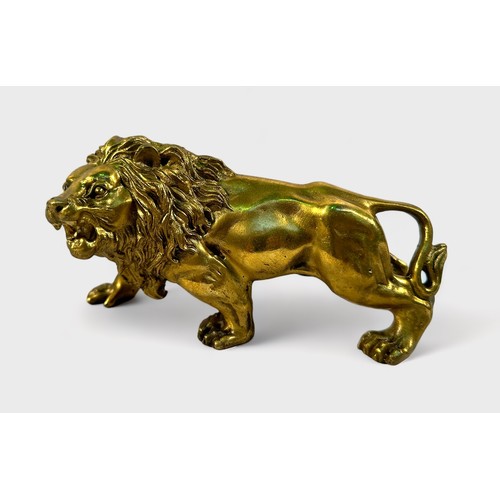 373 - A gilt cast copper alloy figure of a lion, prowling and snarling, 15cm