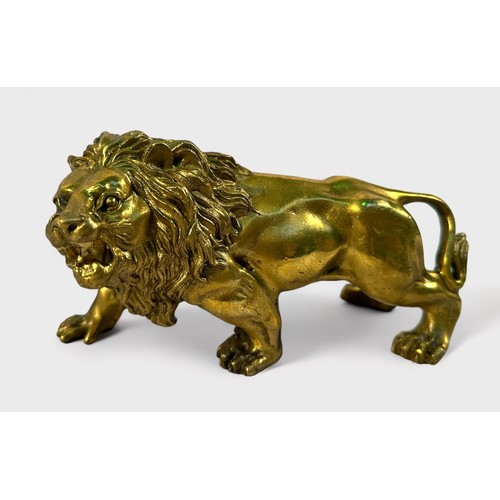 373 - A gilt cast copper alloy figure of a lion, prowling and snarling, 15cm