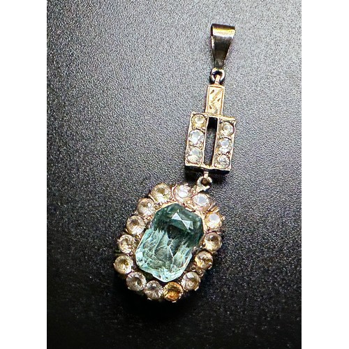 250 - A yellow metal, tests as 9ct gold or above pendant, set with a large oval faceted turquoise coloured... 