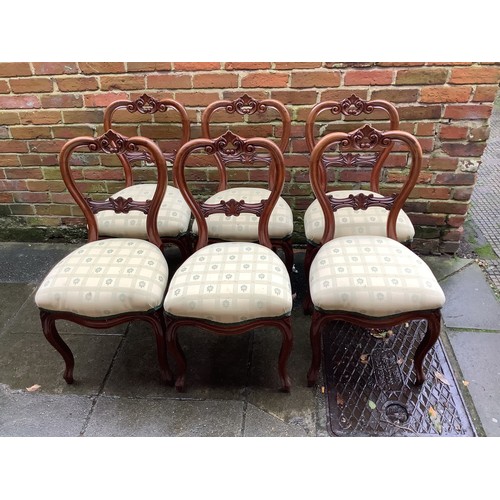 625 - A set of six Victorian style mahogany balloon back standard chairs, with yellow upholstered floral s... 