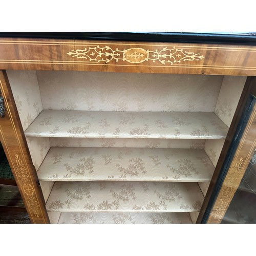 609 - A Victorian inlaid walnut pier cabinet, with single central glazed door enclosing three shelves, rai... 