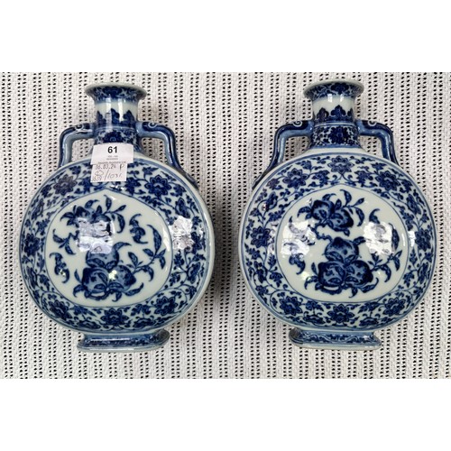 61 - A pair of 20th century Chinese porcelain moon-flasks, of typical form and with blue and white floral... 