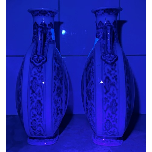 61 - A pair of 20th century Chinese porcelain moon-flasks, of typical form and with blue and white floral... 