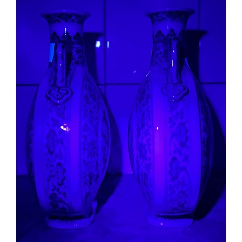 61 - A pair of 20th century Chinese porcelain moon-flasks, of typical form and with blue and white floral... 