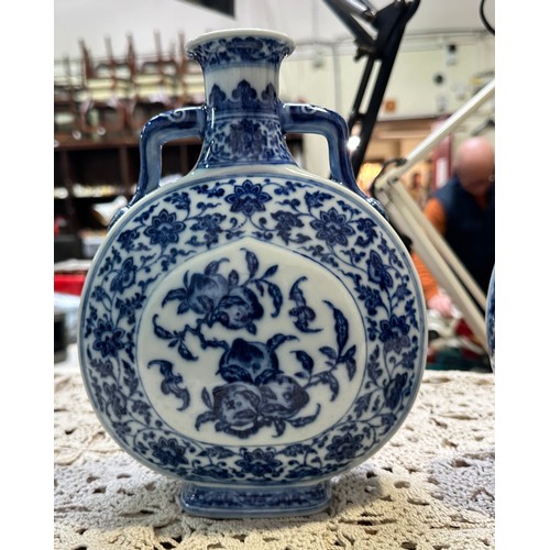 61 - A pair of 20th century Chinese porcelain moon-flasks, of typical form and with blue and white floral... 