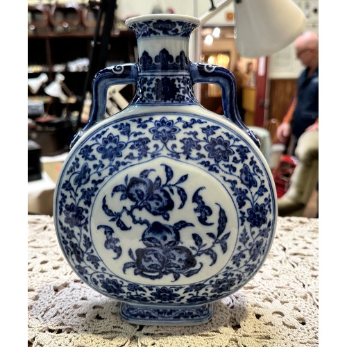 61 - A pair of 20th century Chinese porcelain moon-flasks, of typical form and with blue and white floral... 