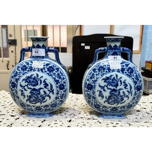 61 - A pair of 20th century Chinese porcelain moon-flasks, of typical form and with blue and white floral... 