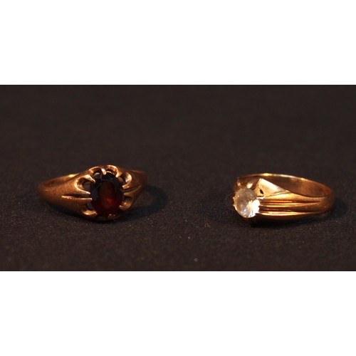 147 - Two various signet rings, one centrally set with a white stone, the other claw set with a garnet col... 