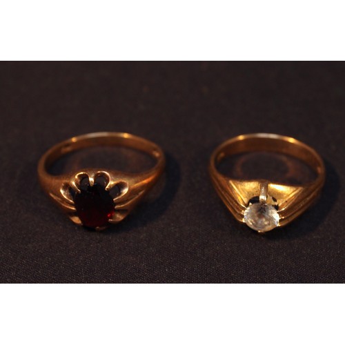 147 - Two various signet rings, one centrally set with a white stone, the other claw set with a garnet col... 