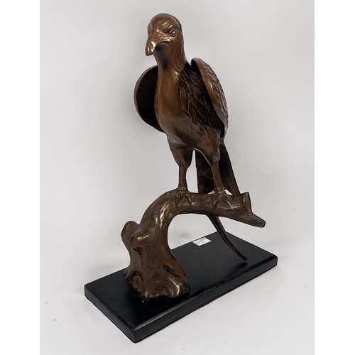 598 - A copper alloy sculpture of an eagle perched on a branch, raised on stained wooden pedestal base, 42... 