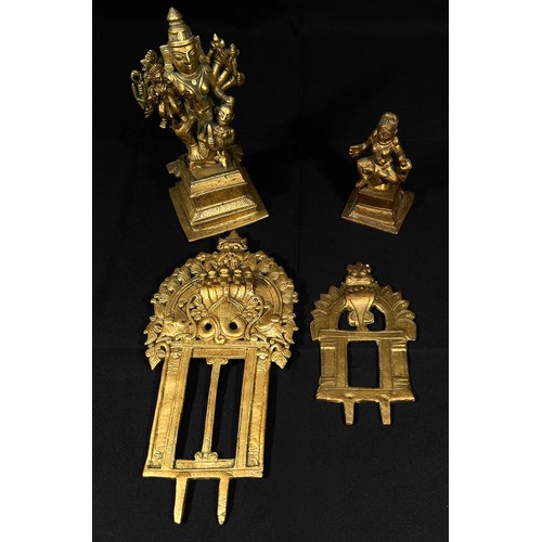 597 - Two copper alloy sculptures of Indian Deities, each with removable back sections, raised on pedestal... 