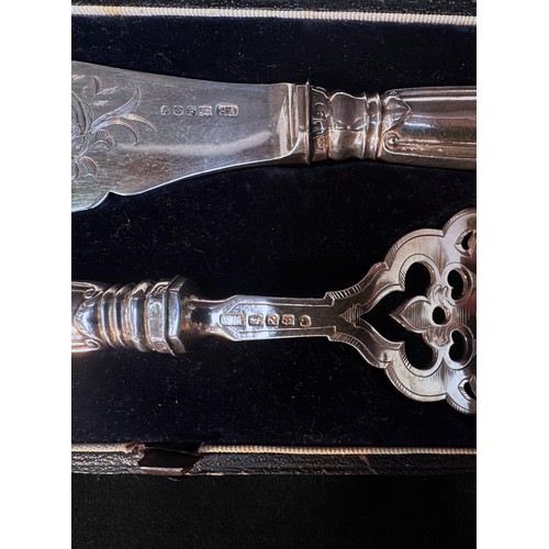 71 - A pair of Victorian silver fish servers with scrolling foliate engraved blades, one side a vacant ca... 