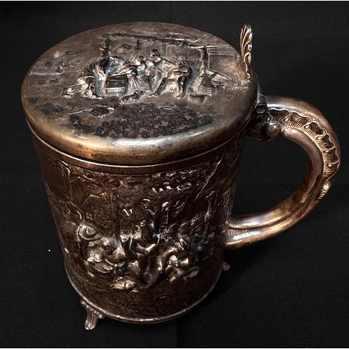 75 - A continental white metal tankard, of cylindrical form and embossed and chased with a pastoral scene... 