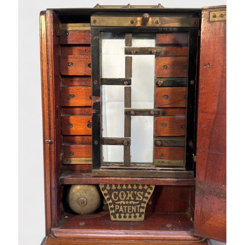 346 - A Late 19th Century walnut Cox's Patent Till, with glass panel and sliding penny-drop, hinged door  ... 