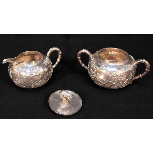 52 - A Chinese Export three-piece white-metal teaset, (tests as .800 silver or higher), of globular form ... 