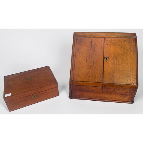 345 - A Victorian slope-fronted oak desk tidy, with a pair of hinged doors enclosing adjustable calendar, ... 