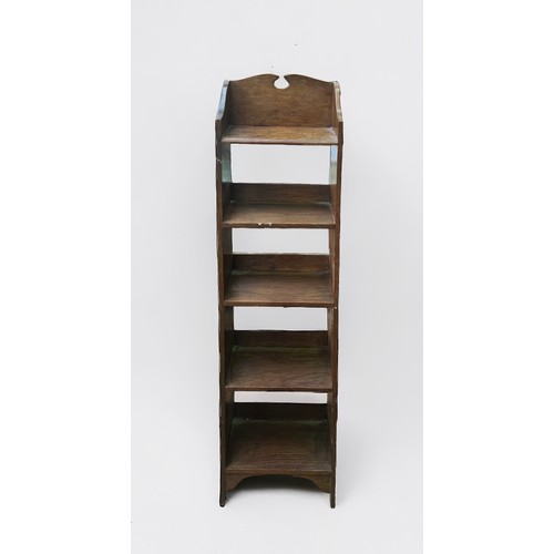 627 - A Liberty & Co 'style' stained oak bookcase, of narrow proportions, with fret-cut three-quarter gall... 