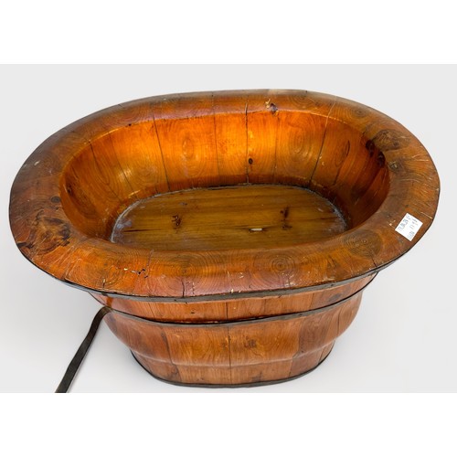 374 - A Chinese coopered oval wooden barrel with detachable baby-bath top, together with a coopered wooden... 