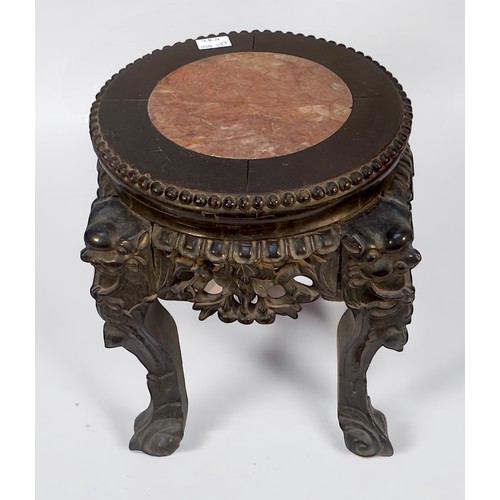 94 - A Chinese carved and ebonised hardwood jardiniere stand, with mask-capped cabriole supports and inse... 