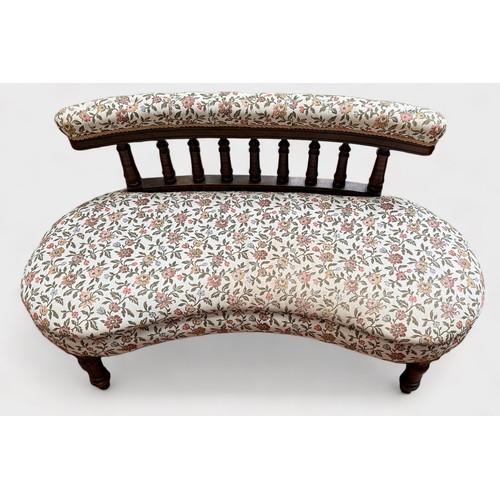 630 - An Edwardian kidney-shaped parlour sofa, with bobbin spindle back and floral cream upholstered back ... 