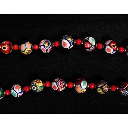 182 - A Murano style millefiori bead necklace, interspersed with red and yellow metal beads