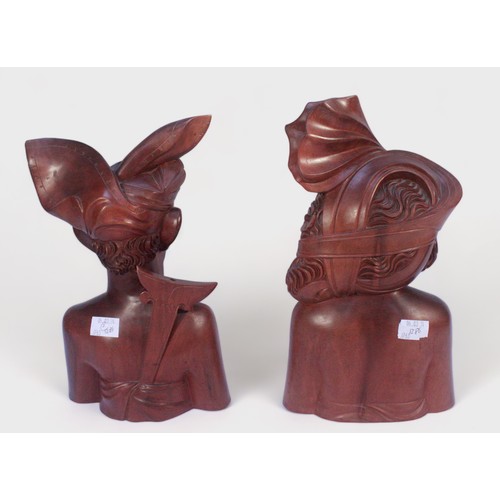 401 - A pair of Balinese carved hardwood busts of a male and female native, both signed to underside, 32cm... 