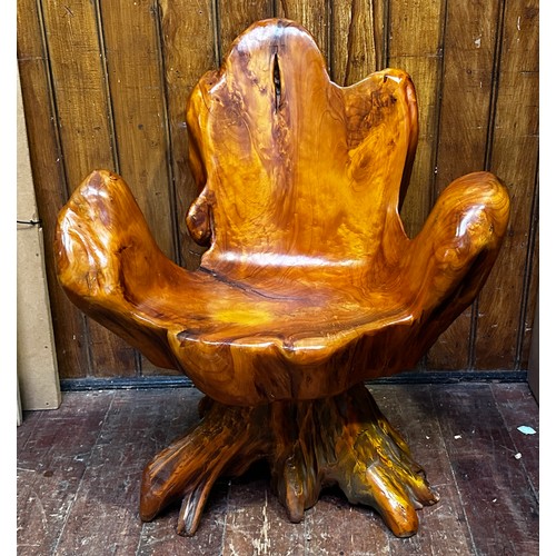 639 - A rustic seat carved from a single tree root.