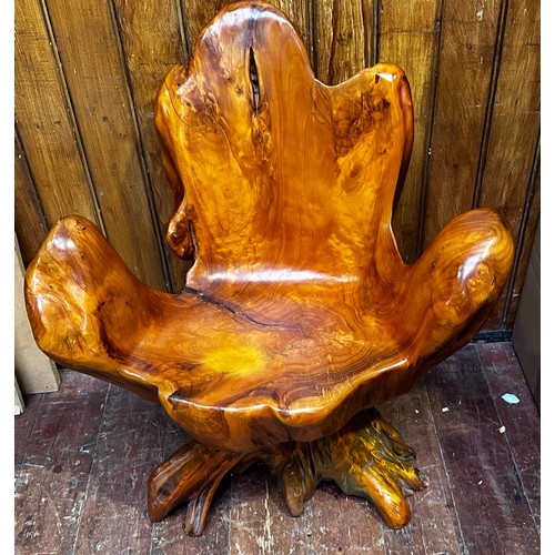 639 - A rustic seat carved from a single tree root.