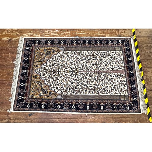 533 - A hand-knotted woollen prayer rug worked with tree of life to a beige central ground within blue bor... 