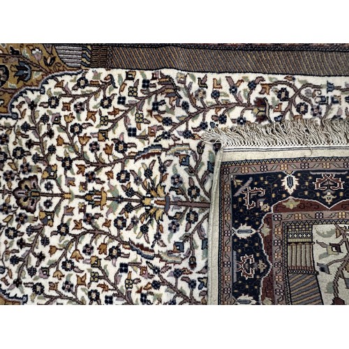 533 - A hand-knotted woollen prayer rug worked with tree of life to a beige central ground within blue bor... 