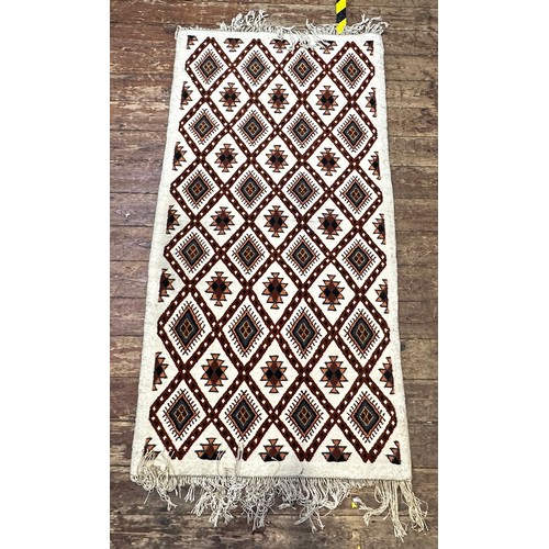 535 - A Caucasian woollen carpet, with a trellis design with stylised guls, and fringed ends, approximatel... 