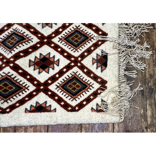 535 - A Caucasian woollen carpet, with a trellis design with stylised guls, and fringed ends, approximatel... 