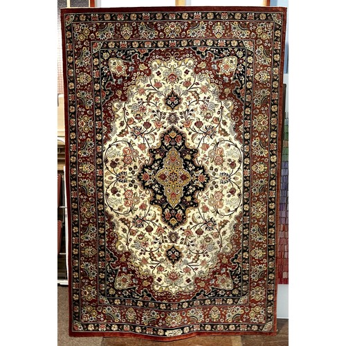 534 - A Persian rug, probably silk and wool, central medallion to a cream field with spandrels, multi bord... 