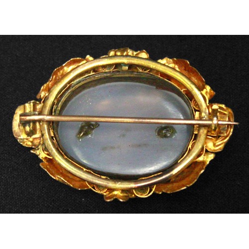 218 - A Victorian yellow metal brooch, (tests as 14ct gold or above), centrally set with an oval moonstone... 