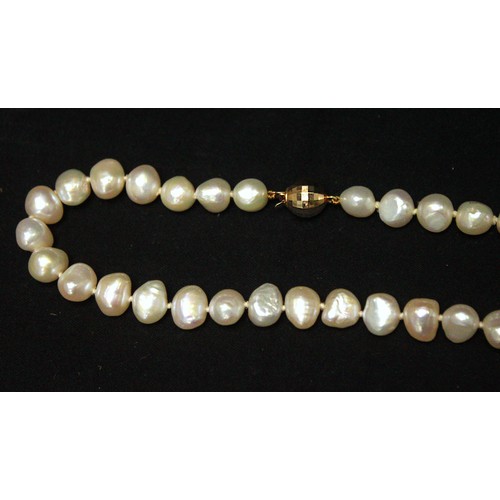 262 - A string of cultured baroque pearls, with 14ct gold faceted spherical clasp, in Artisans of the Sea ... 