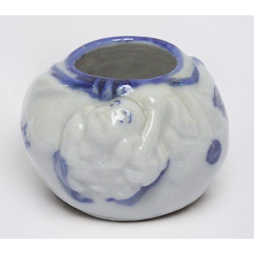 60 - A Japanese porcelain brush washer, of compressed globlar form with relief-moulded Hotei Buddha and p... 