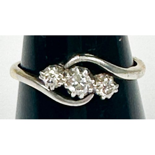 153 - An 18ct yellow gold ring, platinum set with three round diamonds in a twist design, total estimated ... 