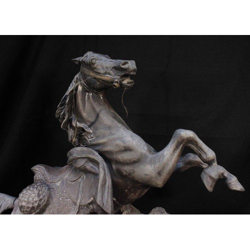 615 - A large patinated spelter figure of a rearing horse on oval base. (tail as found), 56cm high