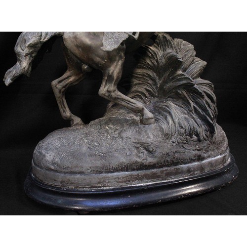 615 - A large patinated spelter figure of a rearing horse on oval base. (tail as found), 56cm high