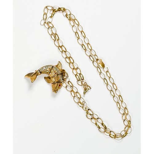 197 - A 9ct yellow gold articulated dolphin pendant, set with white faceted stones to the body and red fac... 