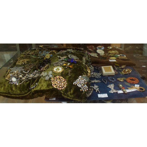 221 - A good quantity of costume jewllery including brooches, earrings, rings, buckles etc, in two clear p... 