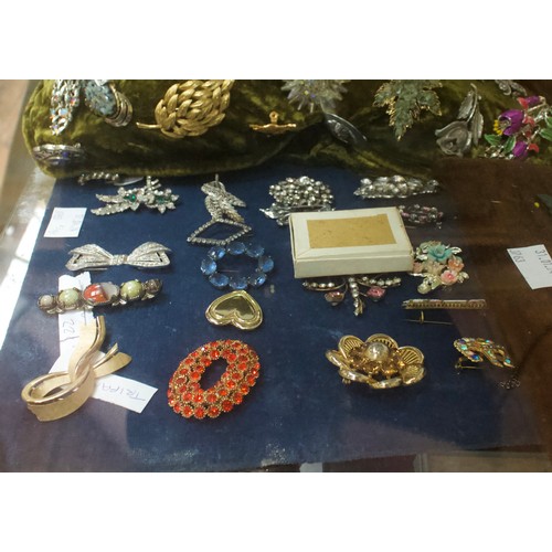 221 - A good quantity of costume jewllery including brooches, earrings, rings, buckles etc, in two clear p... 