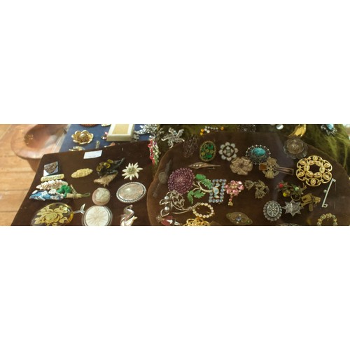 221 - A good quantity of costume jewllery including brooches, earrings, rings, buckles etc, in two clear p... 