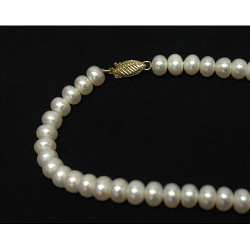 267 - A cultured pearl necklace with 14k gold safety clasp, together with a cultured pearl bracelet with 9... 