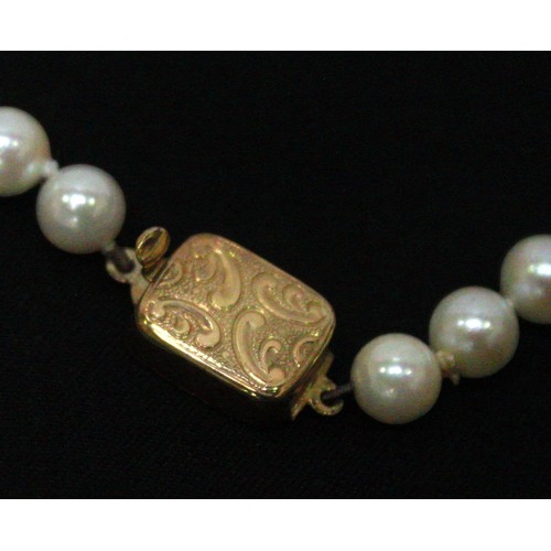 267 - A cultured pearl necklace with 14k gold safety clasp, together with a cultured pearl bracelet with 9... 