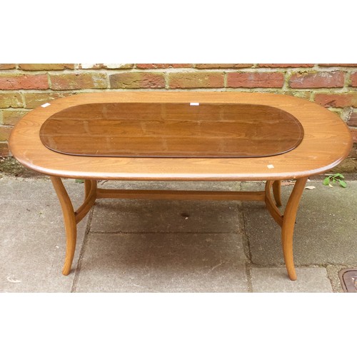 643 - An Ercol elm coffee table, of oval form, raised on downswept supports with stretcher, 115cm long