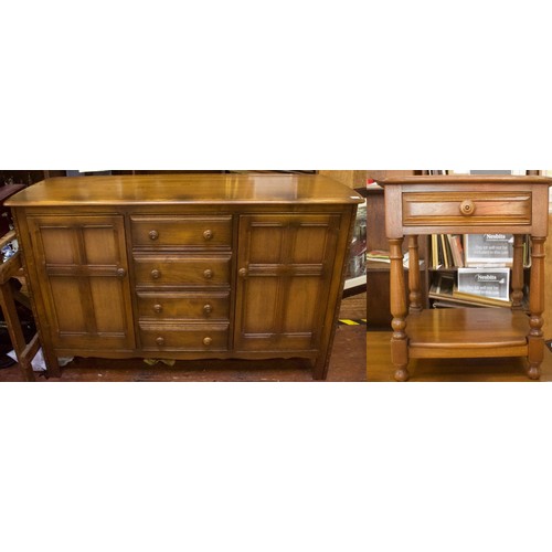 645 - An Ercol elm Colonial sideboard, comprising four short central drawers, flanked by two cupboard door... 